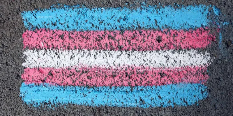 Trans pride flag on road draw with chalk