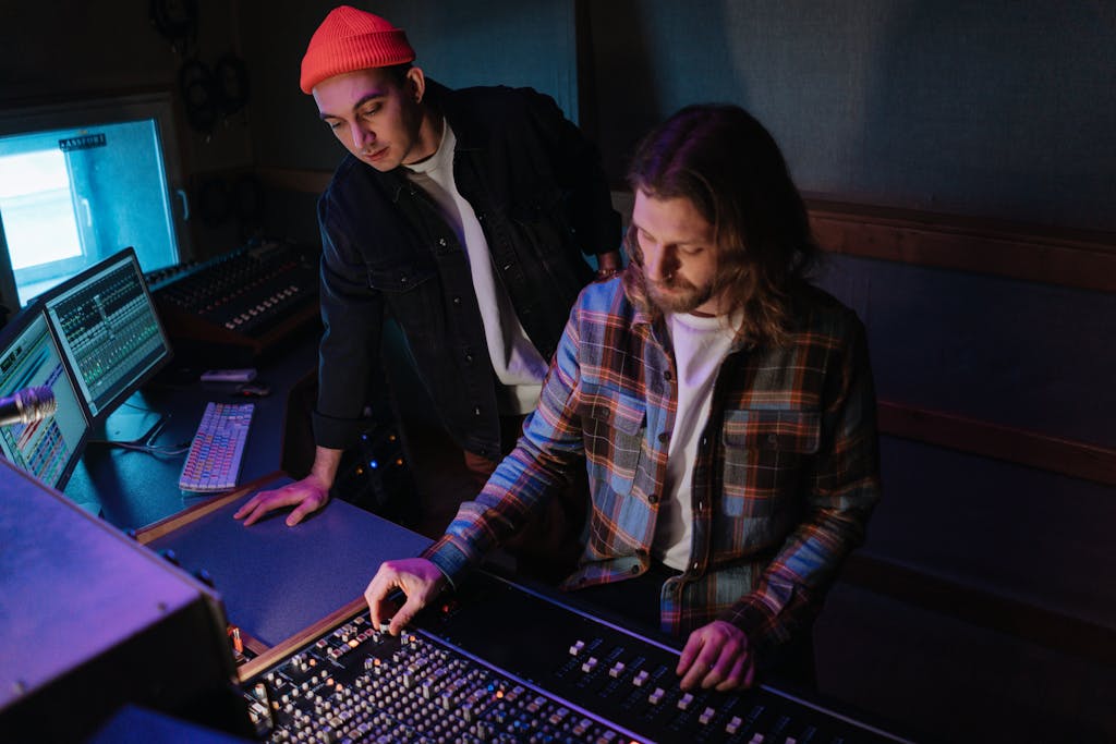 Men in the Recording Studio in Front of the Mixing Board